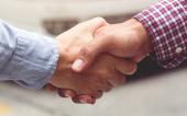 Good deal. Close-up of handshaking. Smooth business.